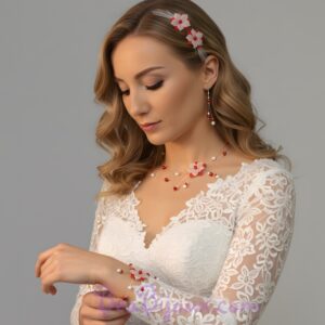 Collier, boucles d'oreilles et bracelet mariage fleur soie rouge et blanche sur fil câblé argenté porté par une mariée